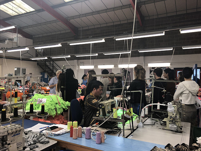 Students at The Factory, Fashion-Enter a London-based manufacturing facility for brands such as ASOS. Here students are shown touring the...