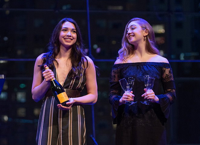 Students assist in kicking off the auction with a bottle of champagne