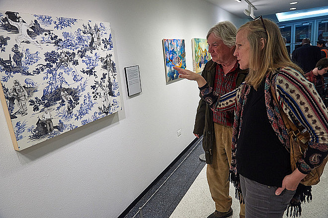 Co-curator Margaret Roleke with work by Laurel Garcia Colvin